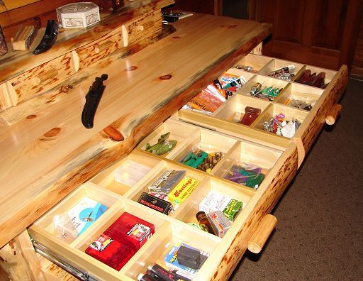 A wooden drawer filled with a variety of toys including hot wheels