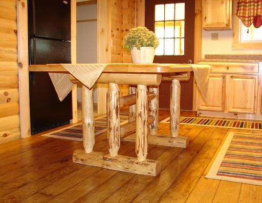 A wooden table with a plant on top of it in a kitchen