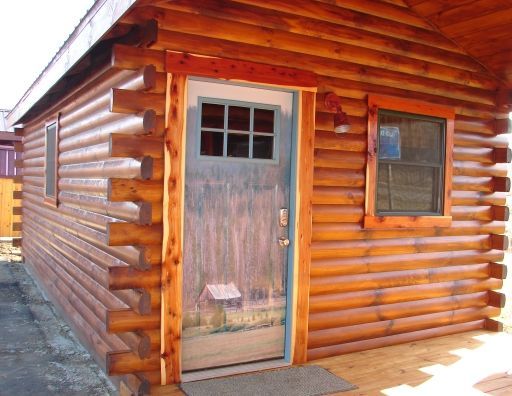 A log cabin with a blue door and window