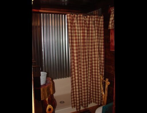 A bathroom with a bathtub and a shower curtain.