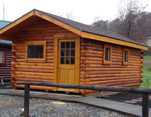 A small log cabin with a door and windows