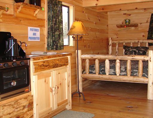 A wooden cabin with a sign on the wall that says 