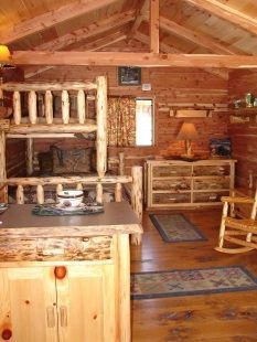 A wooden cabin with a bunk bed and rocking chairs
