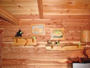 A wooden wall with shelves and pictures on it.