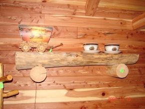 A wooden shelf with two cups and saucers on it.