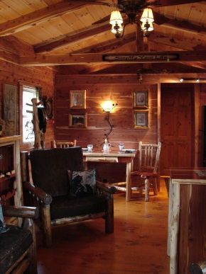A living room with wooden furniture and a ceiling fan