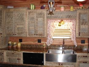 A kitchen with wooden cabinets and a stainless steel sink