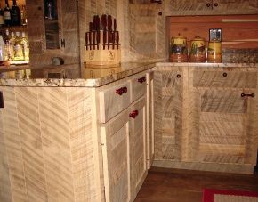 A kitchen with wooden cabinets and a marble counter top