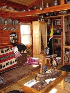 A living room in a log cabin with a sign that says walt 's wild cafe
