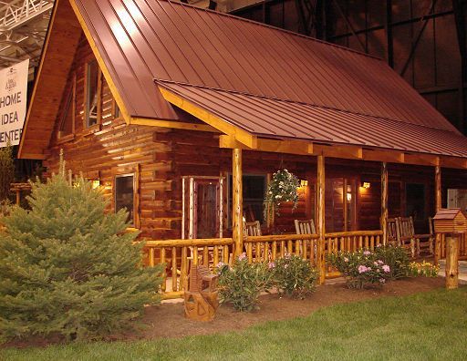 A log cabin with a porch and a sign that says home idea center