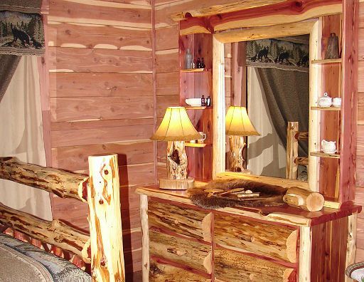 A wooden room with a dresser and a mirror
