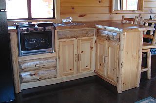 A kitchen with wooden cabinets , a sink , and a stove.