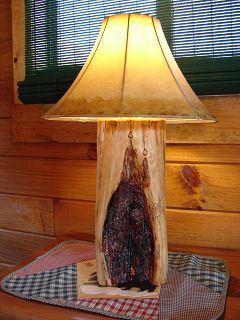 A lamp made out of a tree trunk is sitting on a table.