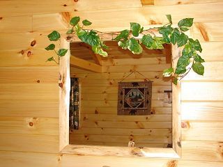 A wooden wall with a mirror and a picture on it