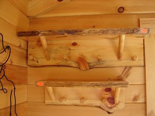 Three wooden shelves are hanging on a wooden wall.