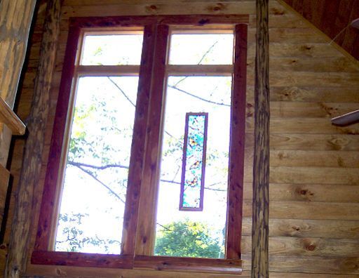 A stained glass window in a wooden building