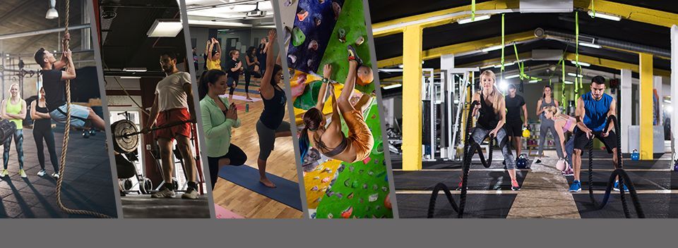People testing rope and climbing obstacles in an indoor gym with colorful mats and equipment.