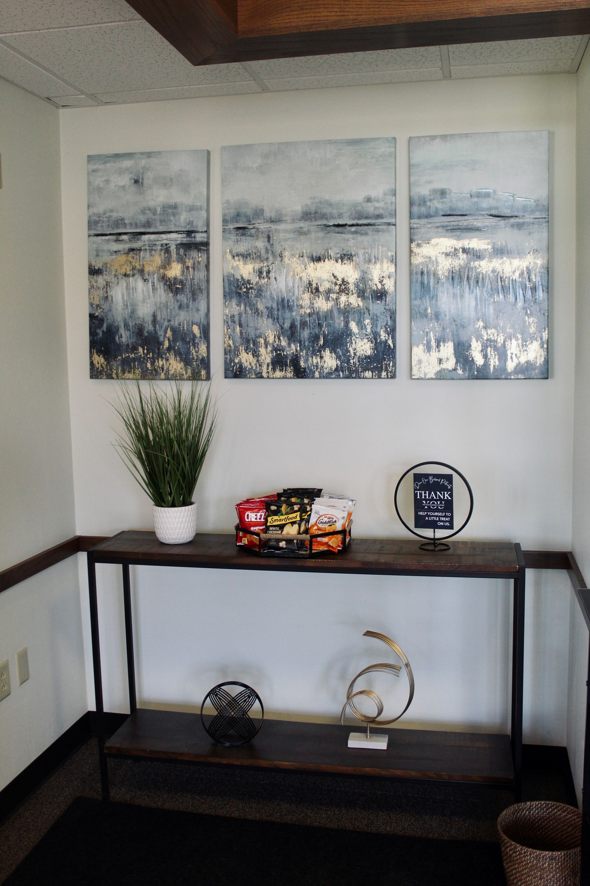Interior scene with console table and artwork.