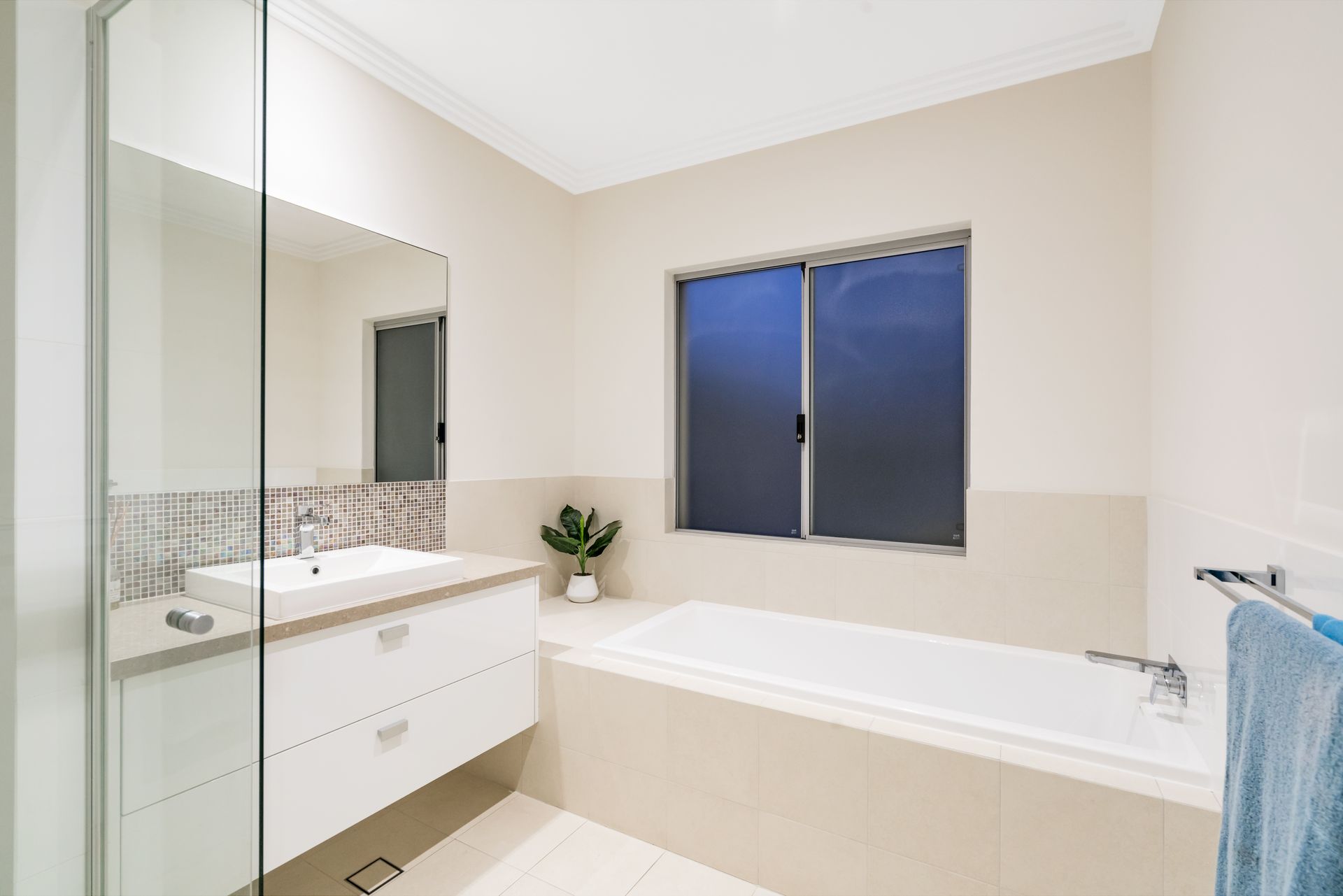 Bathroom With White Tub, Vanity, and Window — Brayden Stewart Building In Forster, NSW