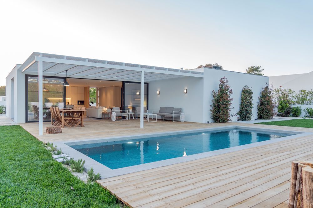 Modern White House With a Pool, Patio, and Green Lawn — Brayden Stewart Building In Forster, NSW