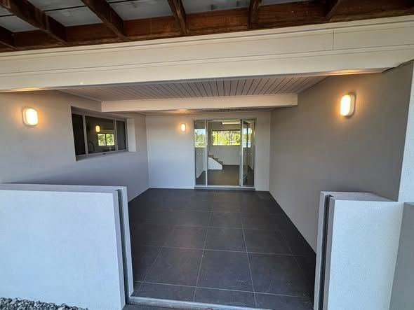 Covered Outdoor Patio With Grey Tile Floor — Brayden Stewart Building In Tuncurry, NSW