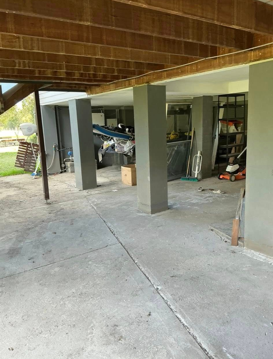 Concrete Patio Under a Deck Supported by Grey Columns — Brayden Stewart Building In Tuncurry, NSW