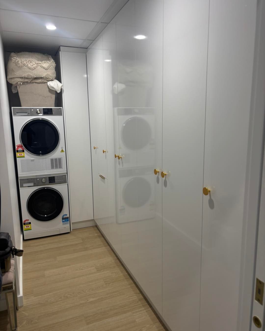 White Laundry Room With Stacked Washer and Dryer — Brayden Stewart Building In Tuncurry, NSW