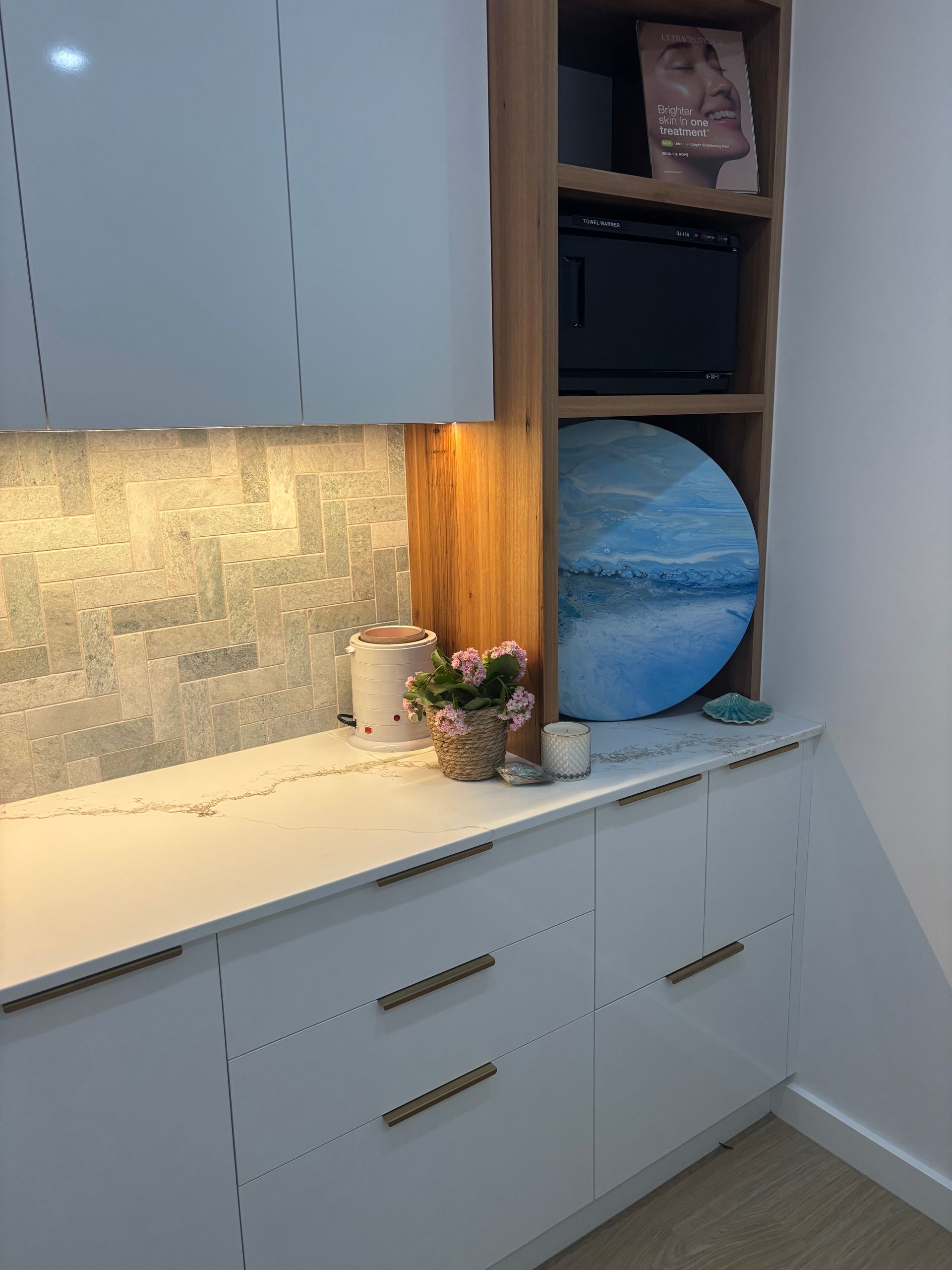 White Cabinets With a Microwave and a Round Blue Painting — Brayden Stewart Building In Tuncurry, NSW