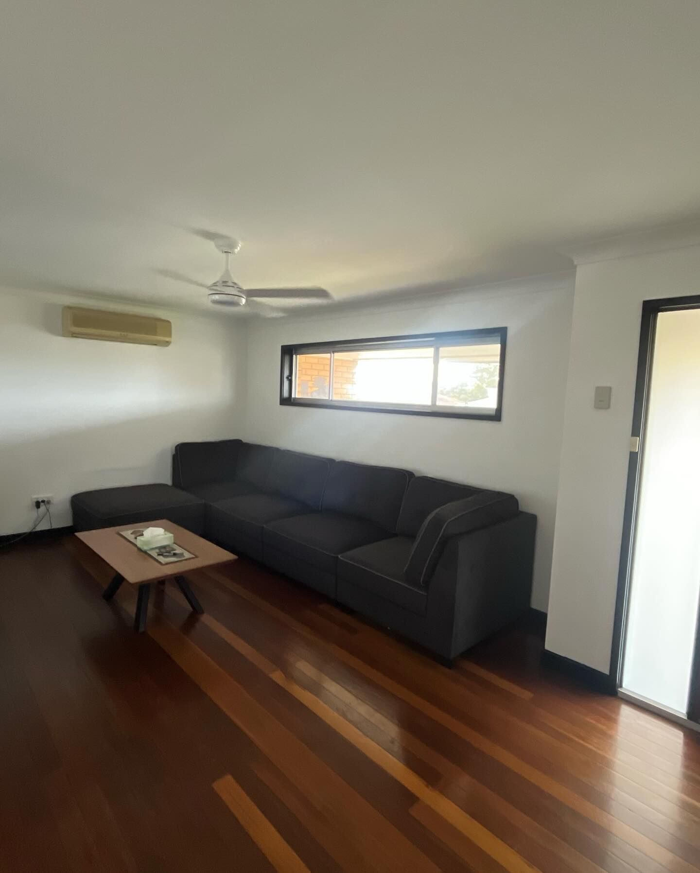 Dark Grey Sectional Sofa in a Living Room — Brayden Stewart Building In Tuncurry, NSW
