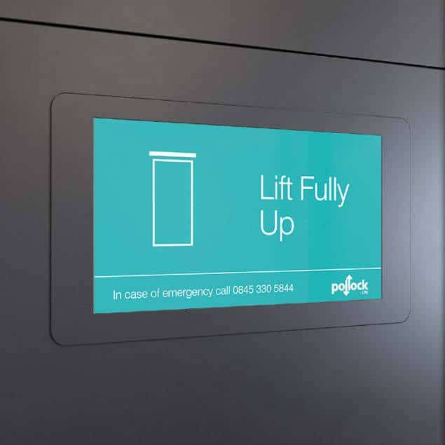 A turquoise digital display on a dark wall reading 