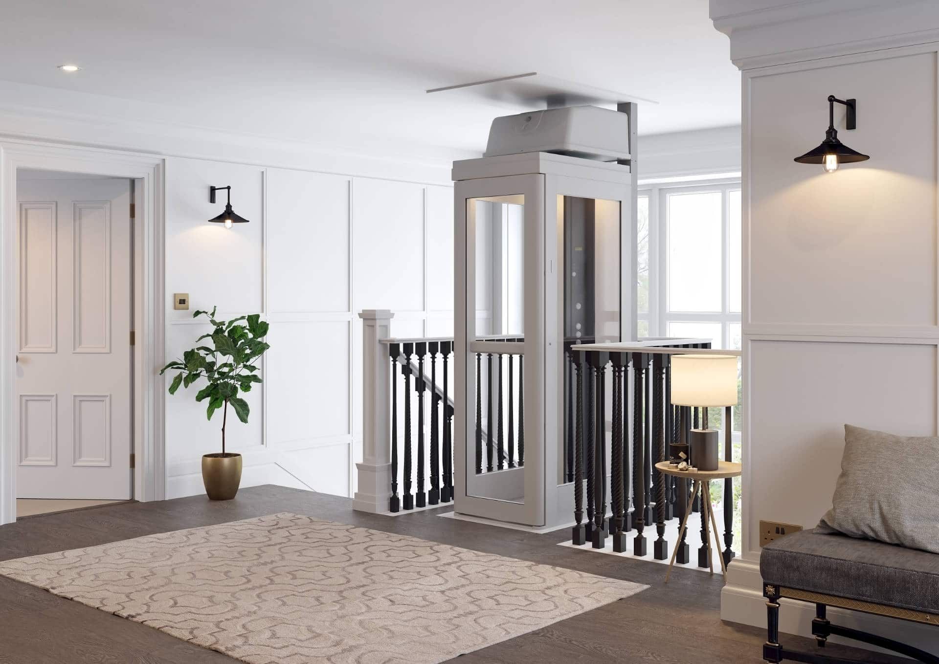 A residential elevator installed in a home landing, positioned beside a staircase with black railings and a neutral rug.