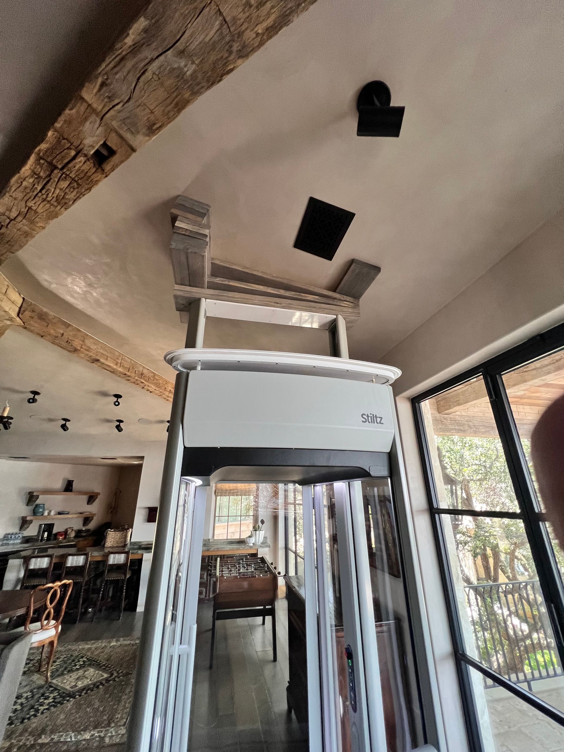 Assembled glass elevator attached to slanted roof