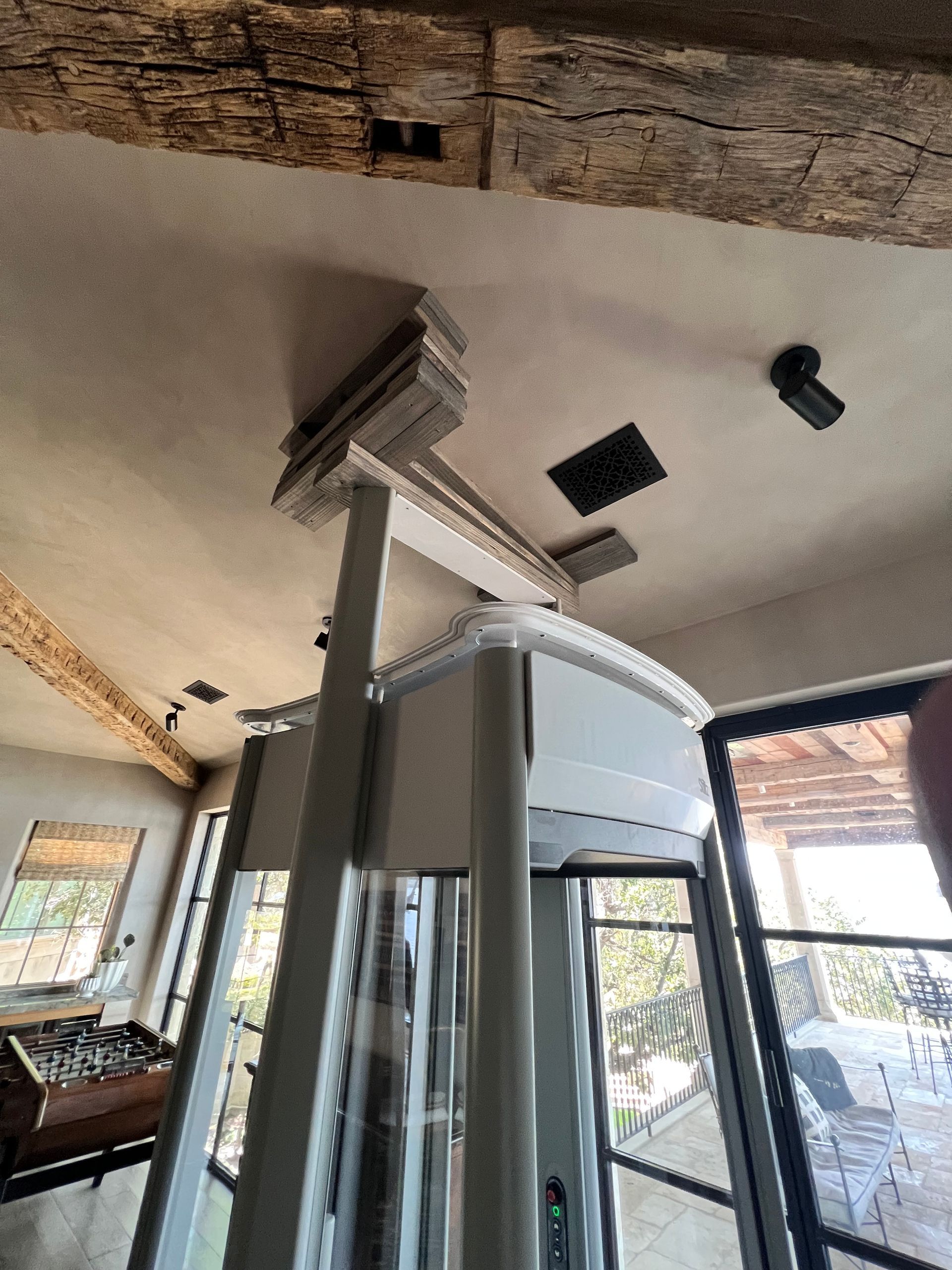Assembled glass elevator attached to slanted roof