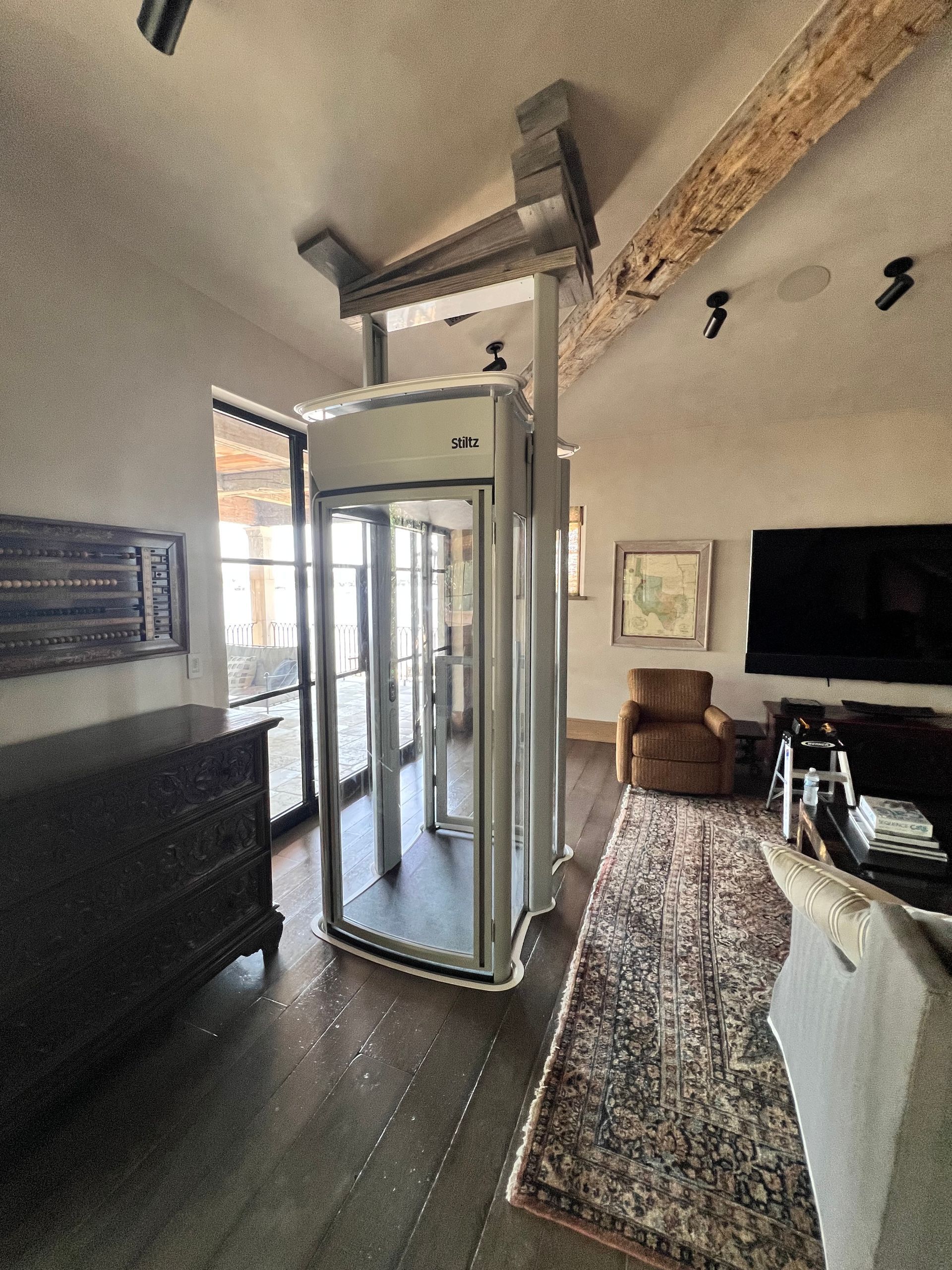 Assembled glass elevator attached to slanted roof