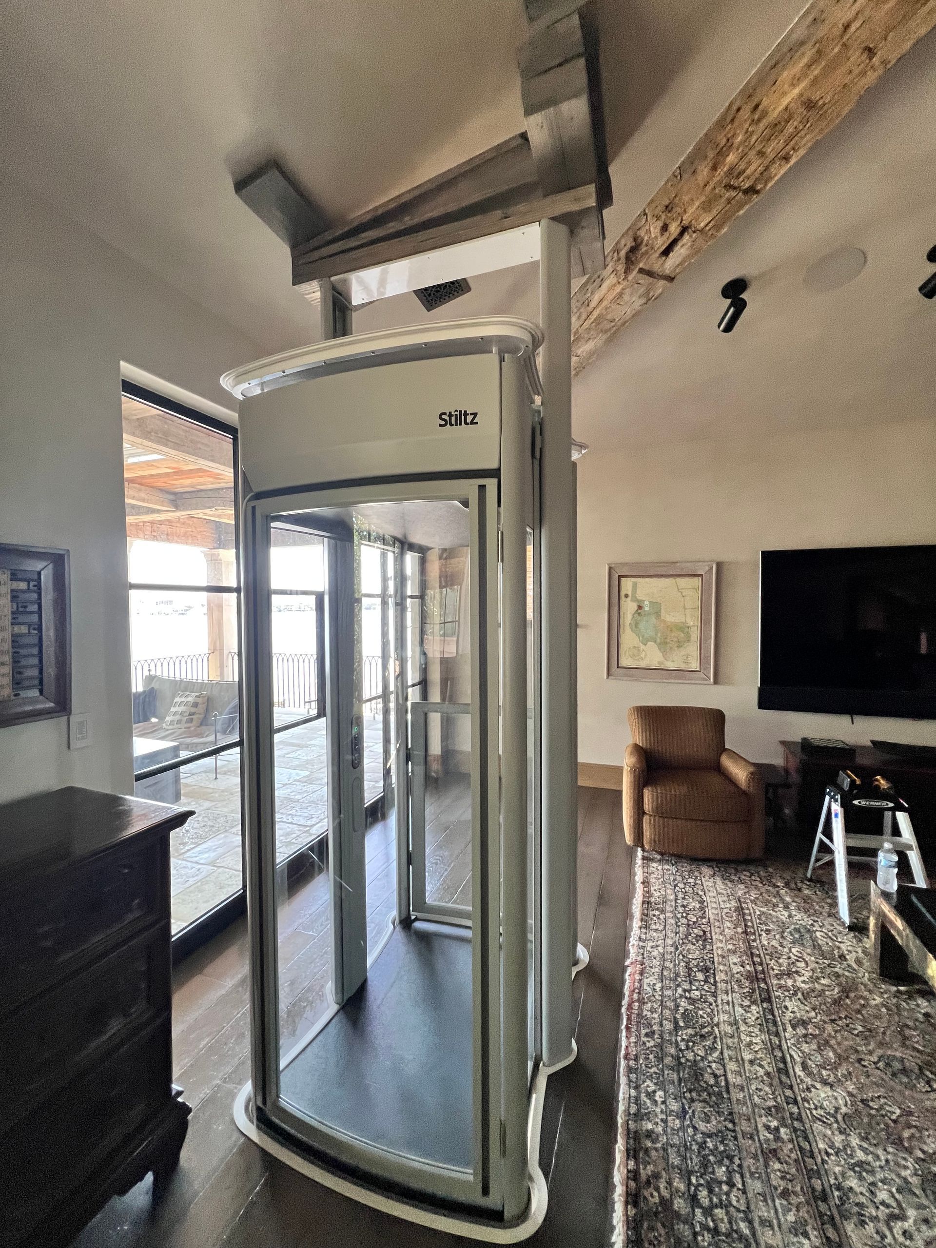 Assembled glass elevator attached to slanted roof