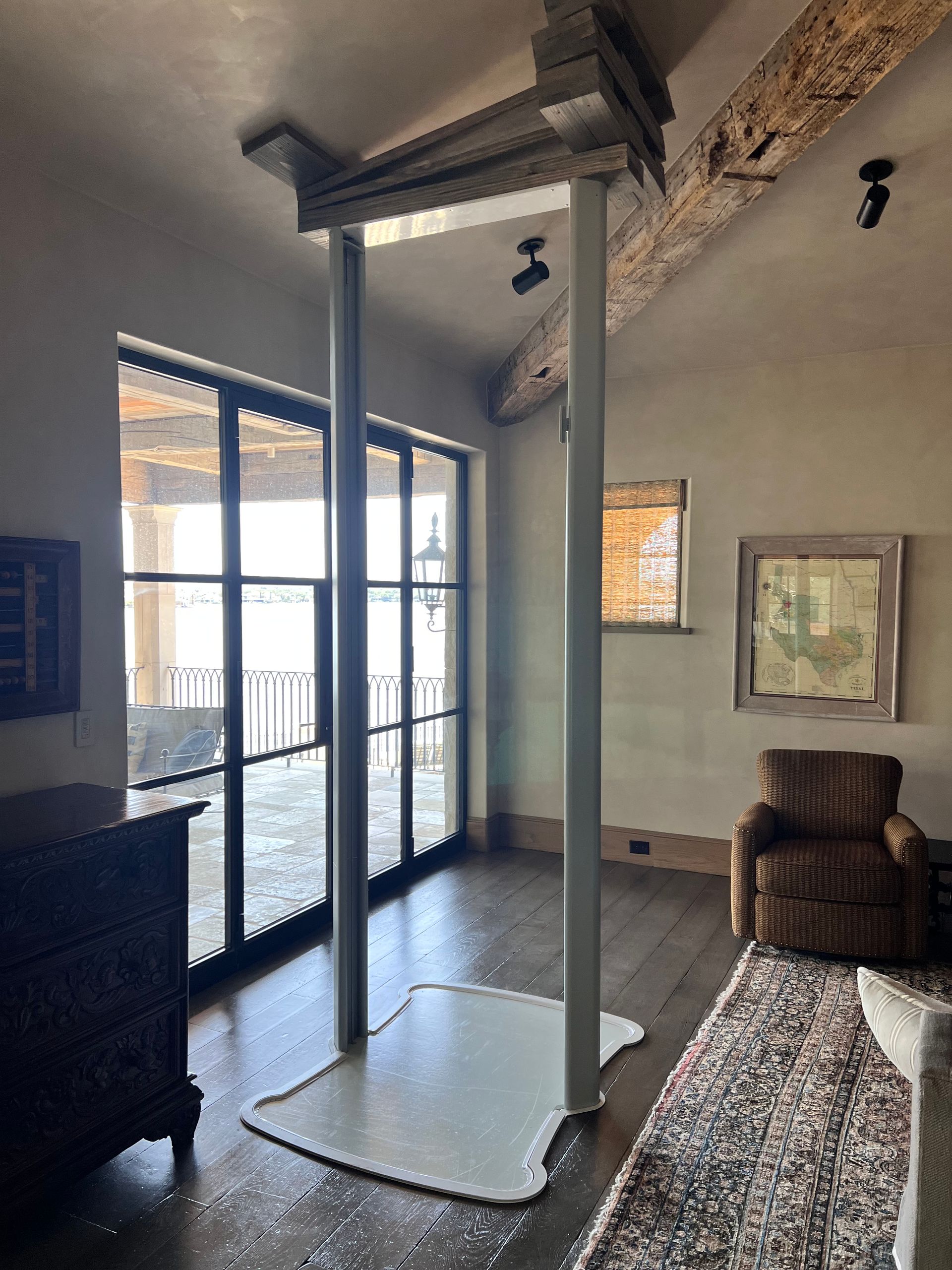 Assembled glass elevator attached to slanted roof