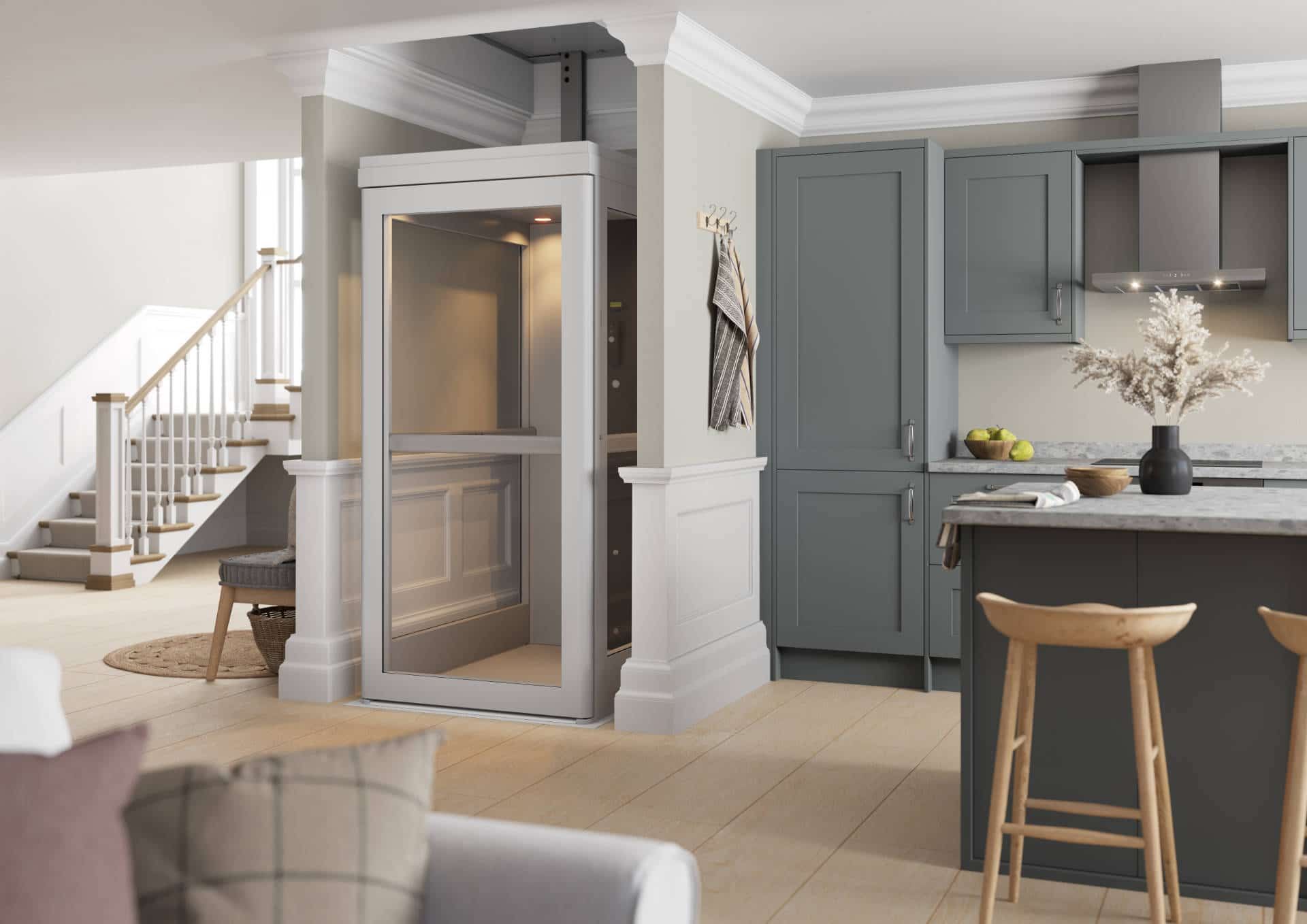 A modern home elevator installed between a kitchen and living area, featuring glass panels and light-colored trim.