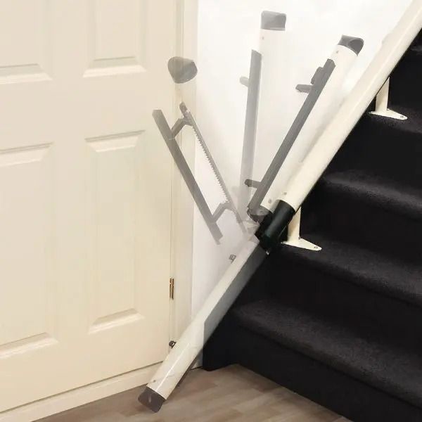 A white, foldable assist rail attached to the bottom of a staircase, shown in both extended and upright positions.