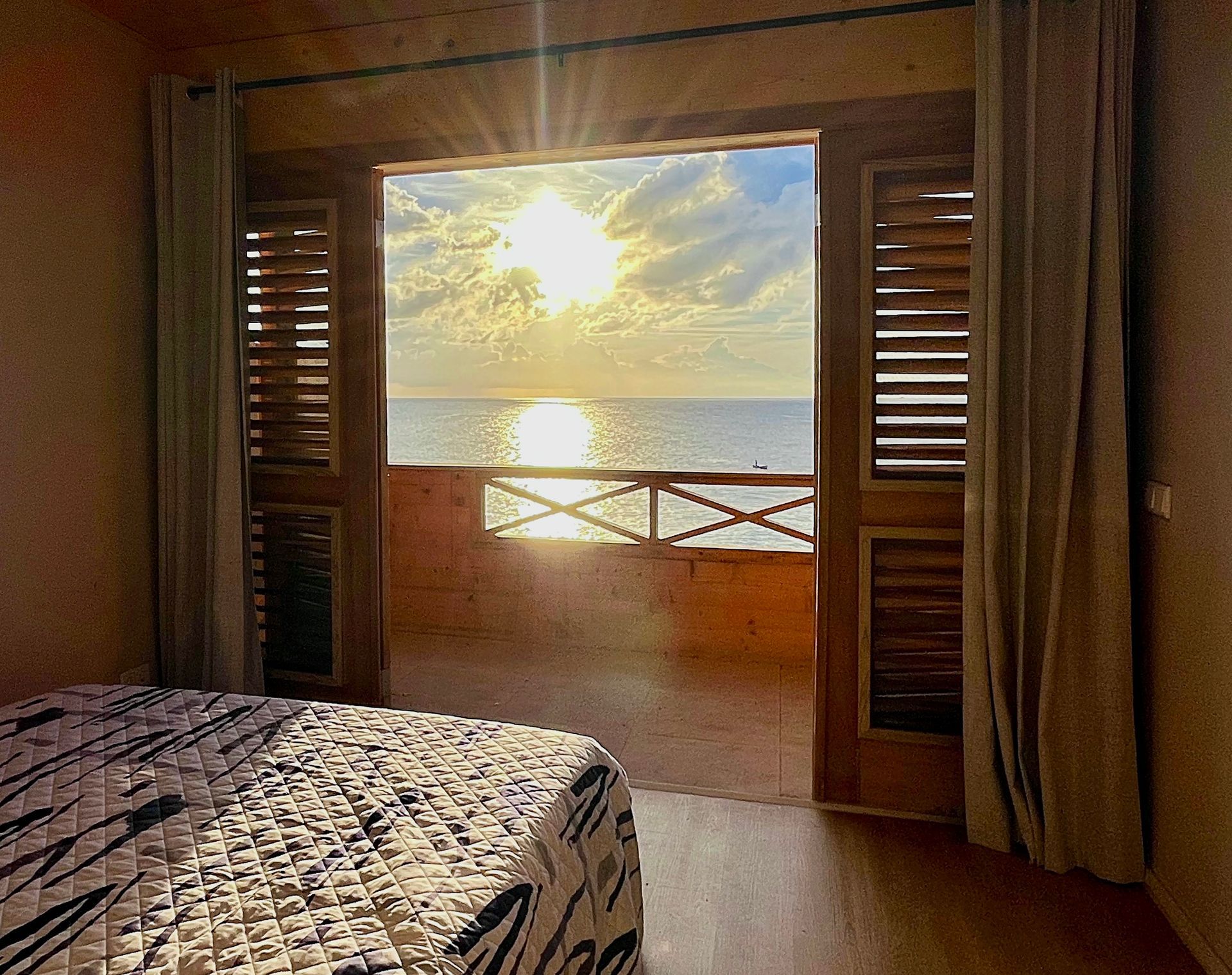 Oceanfront Suite with separate bedroom, a queen size bed, airconditioned, blackout curtains, with outside balcony