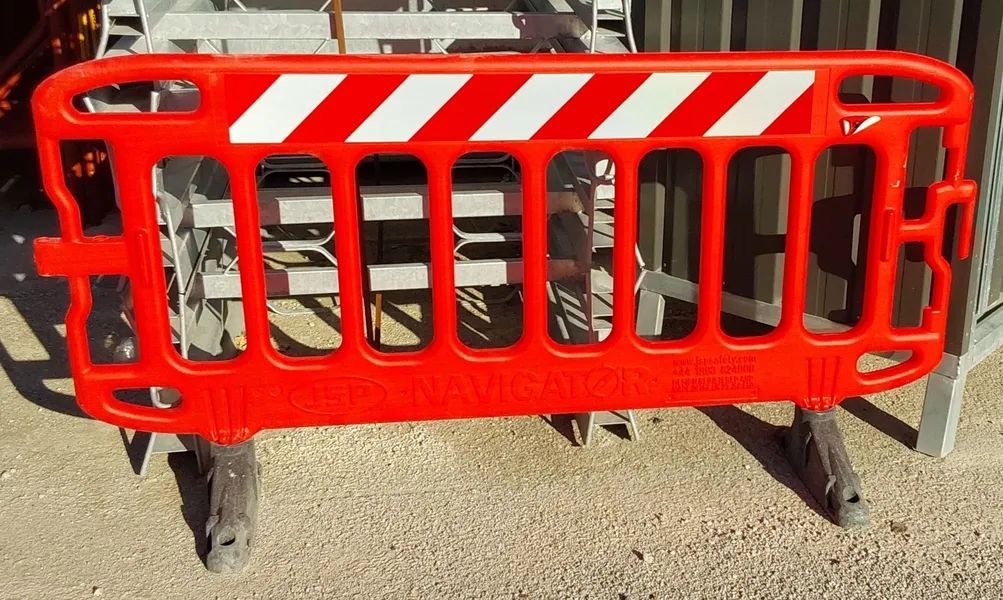Barriera di cantiere rossa con strisce diagonali bianche su una strada
