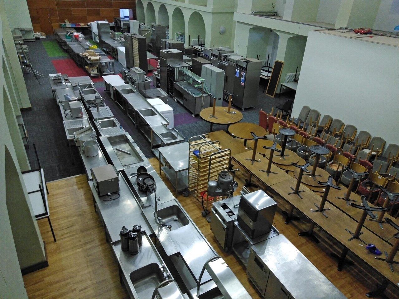 An aerial view of a kitchen with tables and chairs