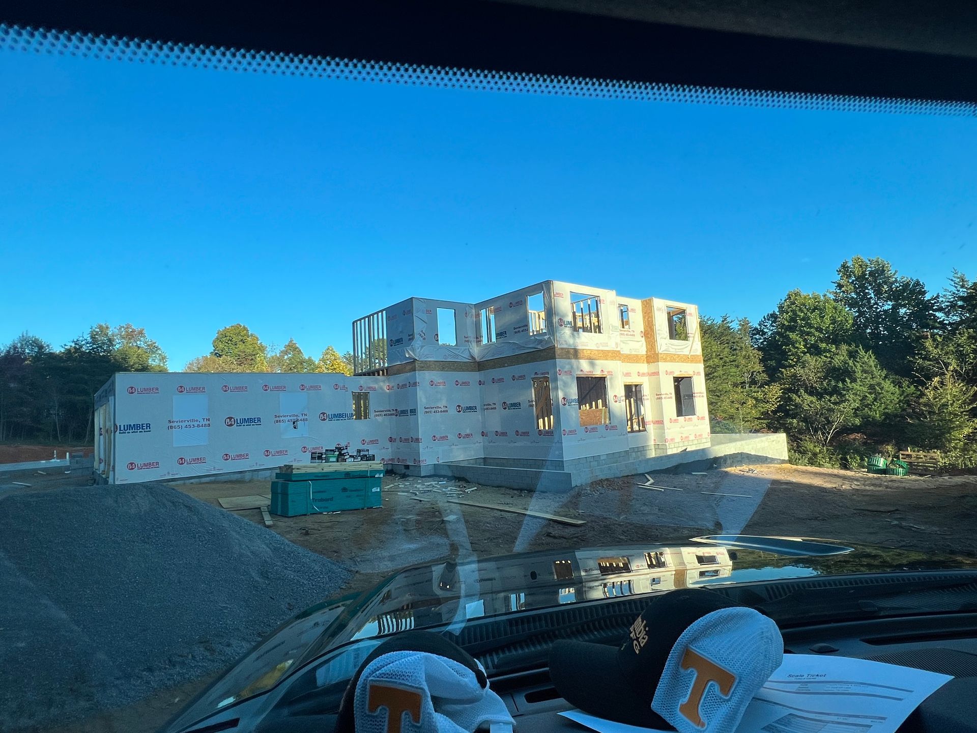 A white truck is parked in a parking lot next to a building.