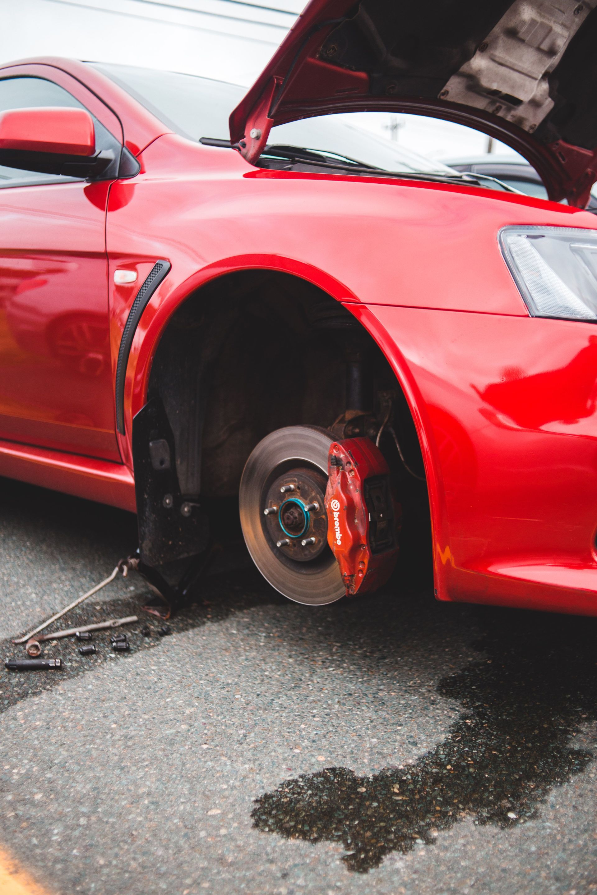 A car lifted for brake repair in our south Austin shop
