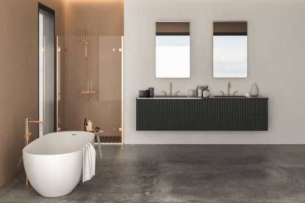 Modern bathroom with a white tub, dark vanity, and two mirrors.
