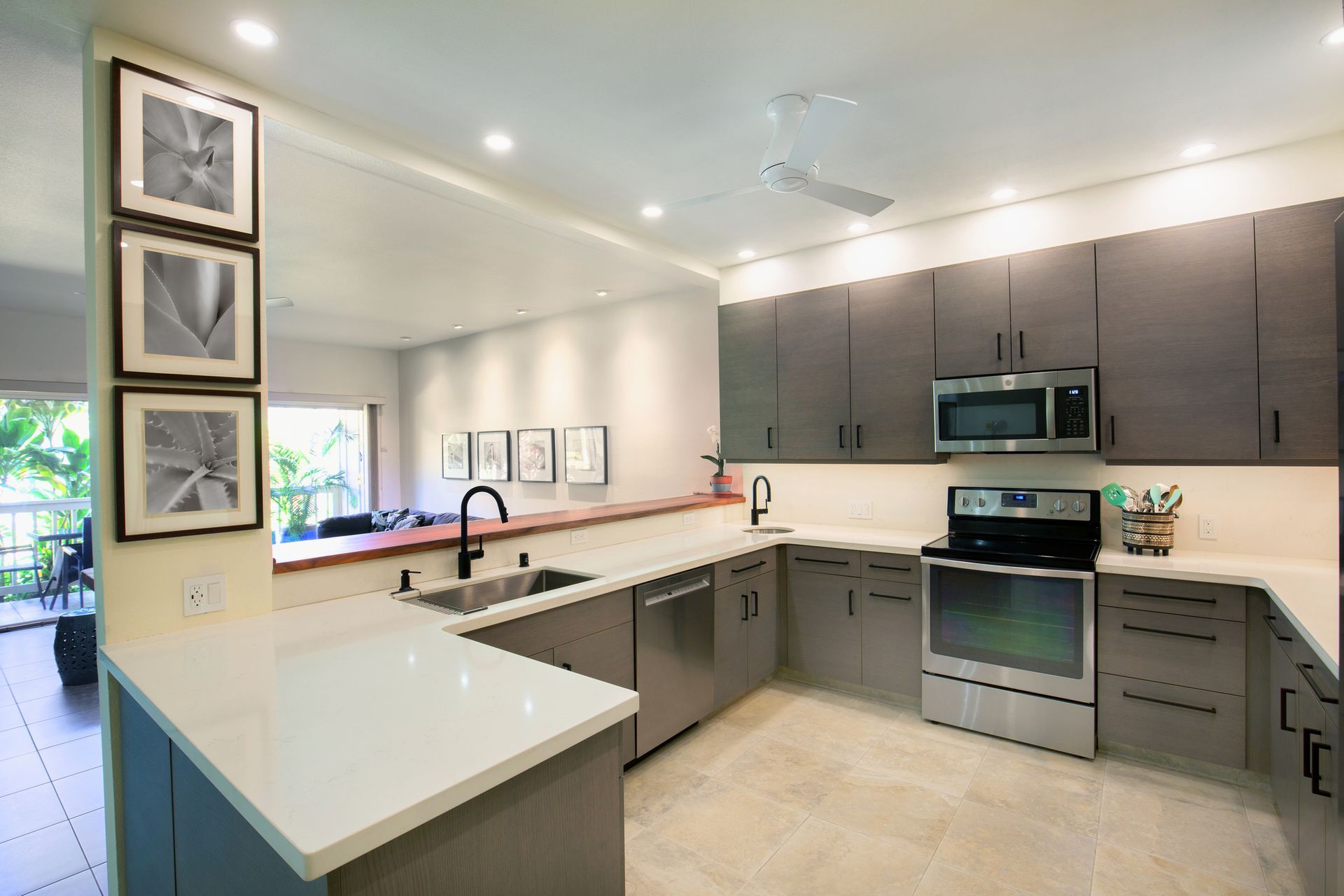 Modern kitchen with gray cabinets, stainless steel appliances, and white countertops. Modern kitchen with gray cabinets, stainless steel appliances, and white countertops.