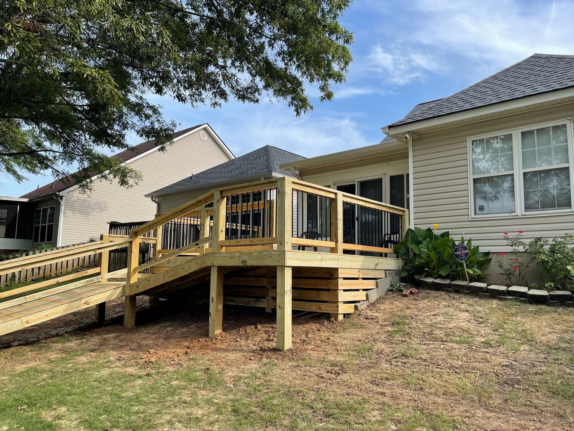 A brick house with a yellow fence in front of it.