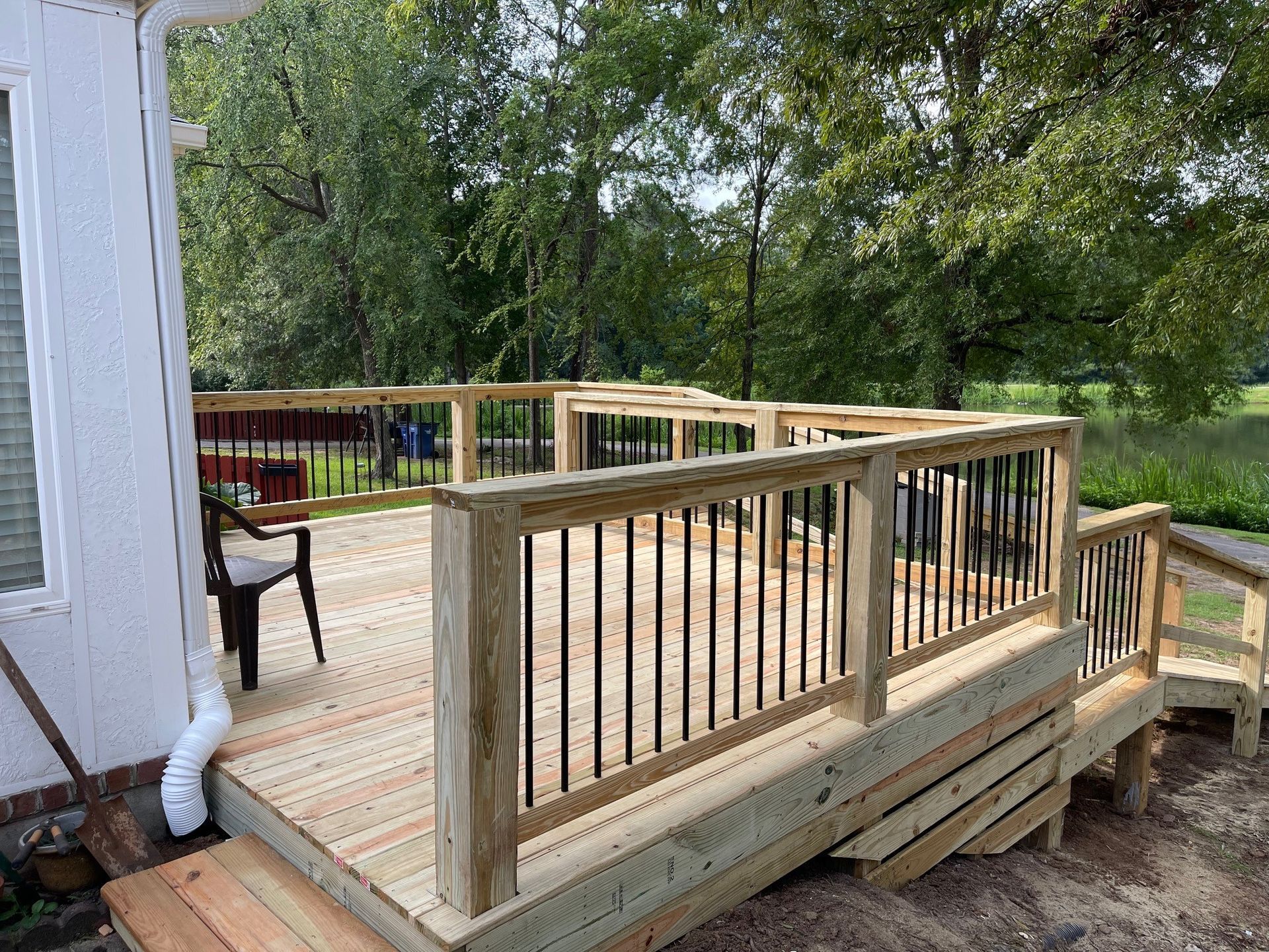 A wooden deck under construction with a blue sky in the background.