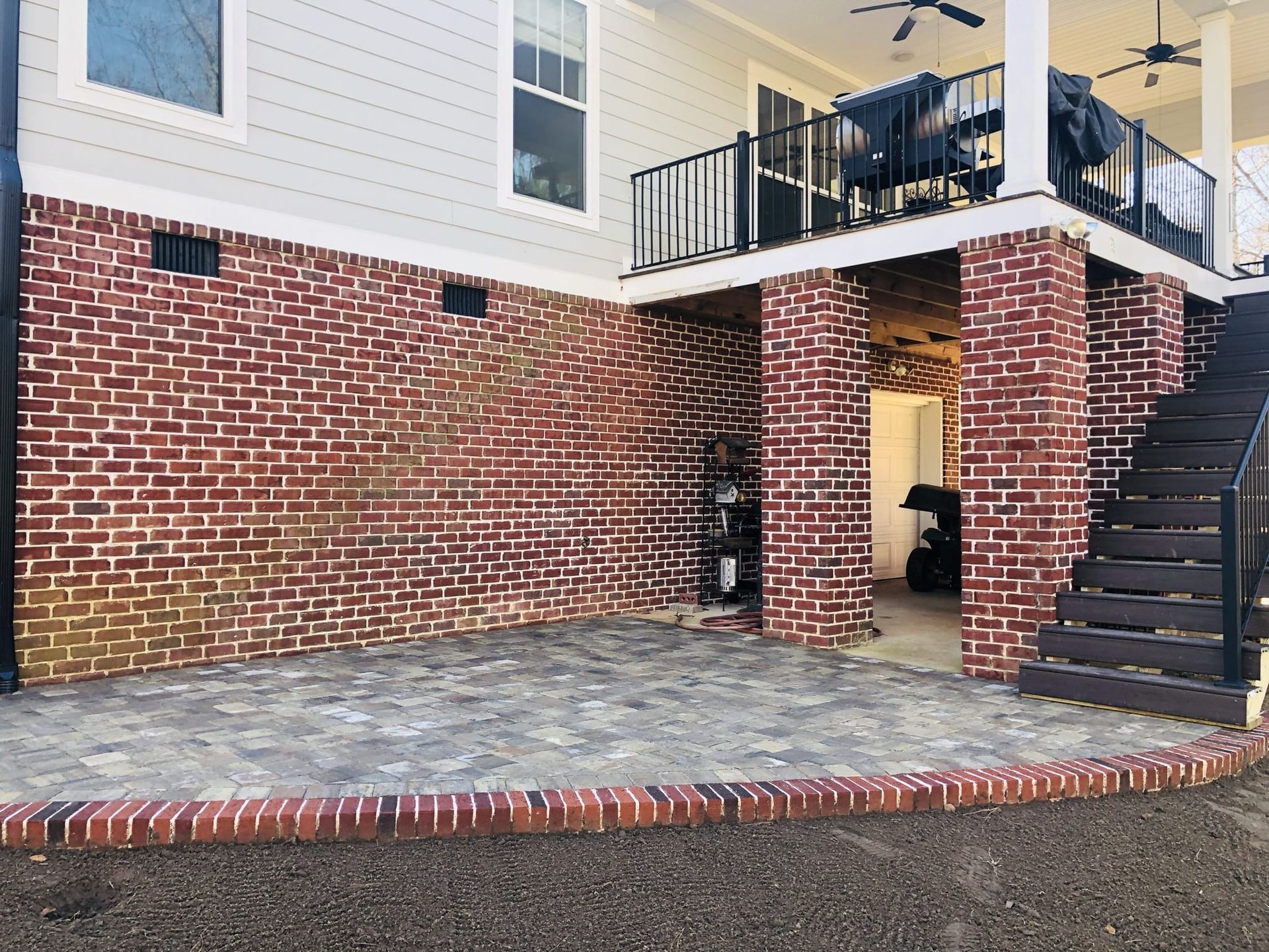 A brick house with a balcony and stairs