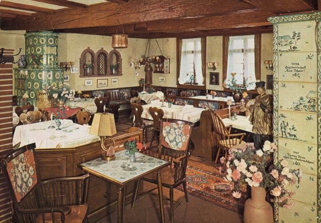 Ein Restaurant mit Tischen und Stühlen und einer Vase mit Blumen