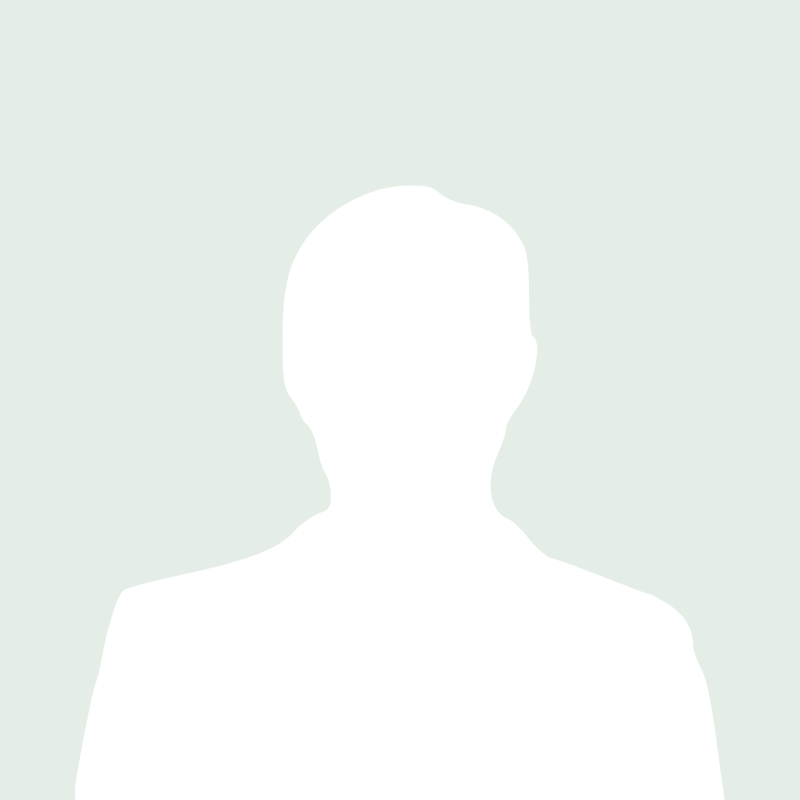 Silhouette of a person wearing a blazer, facing forward on a light green background.